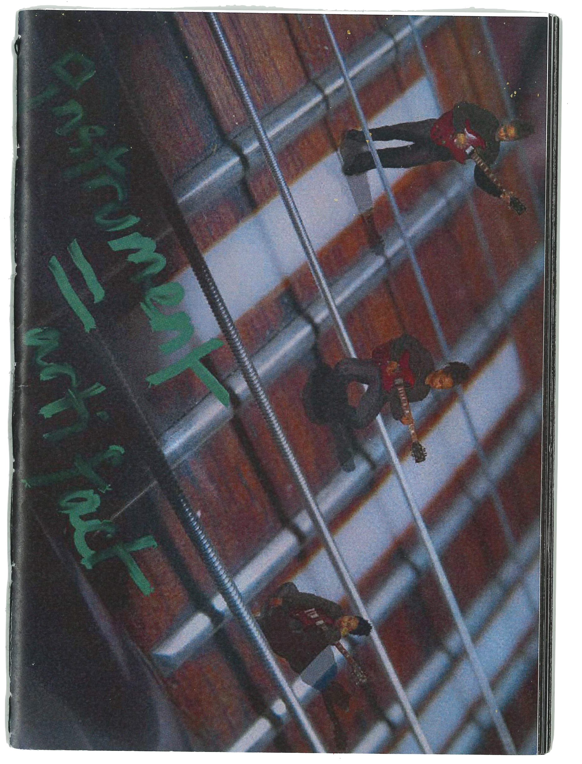 Image of a Magazine cover, it features three small people sitting on the bridge of a guitar